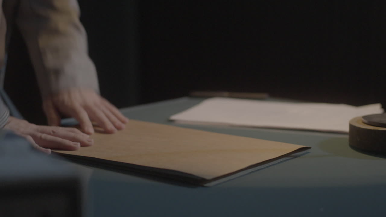 Person reviewing documents at a desk in the night