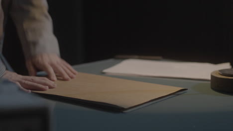 person reviewing documents at a desk in the night