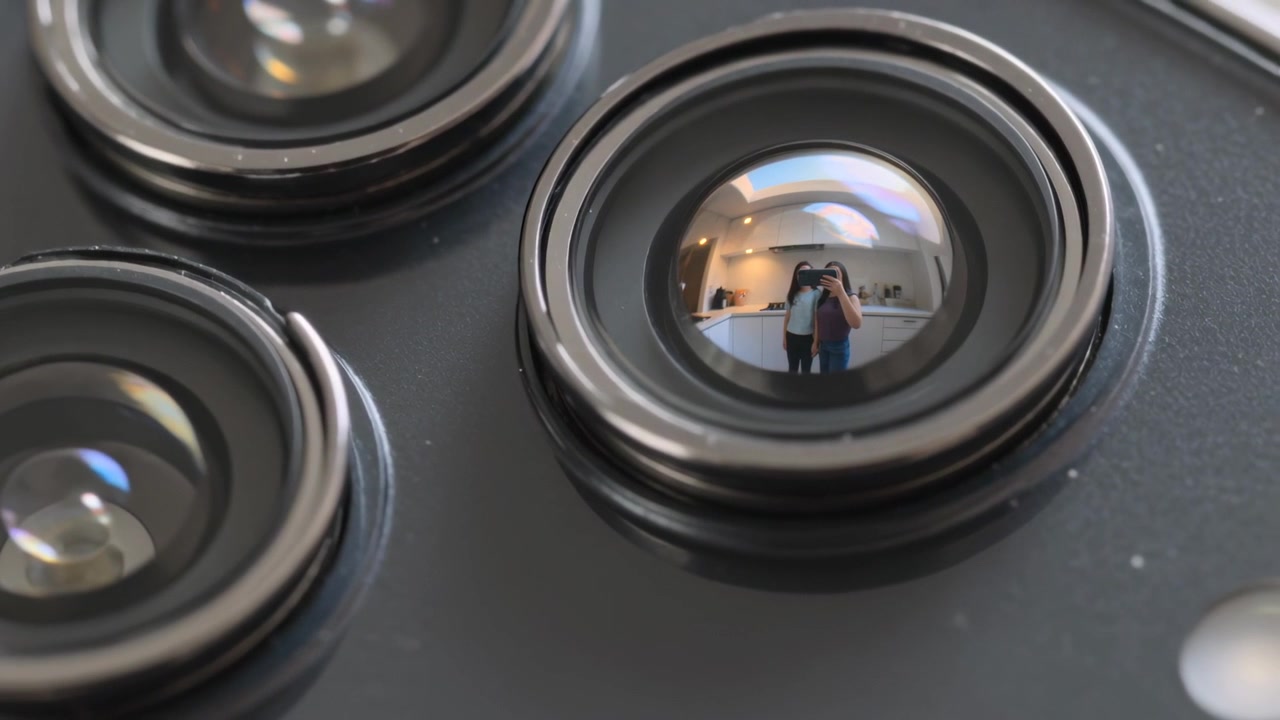 Showing phone lens reflecting pair in kitchen microfocus for demo left light right dark holding cam
