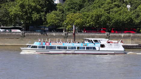 a boat travels along the river thames