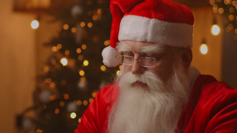 Jolly-Santa-working-on-a-laptop-computer.-Santa-Clause-using-laptop-close-up.-High-quality-4k-footage