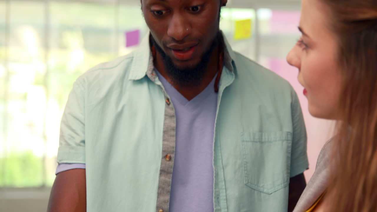 Fashion students working together on laptop