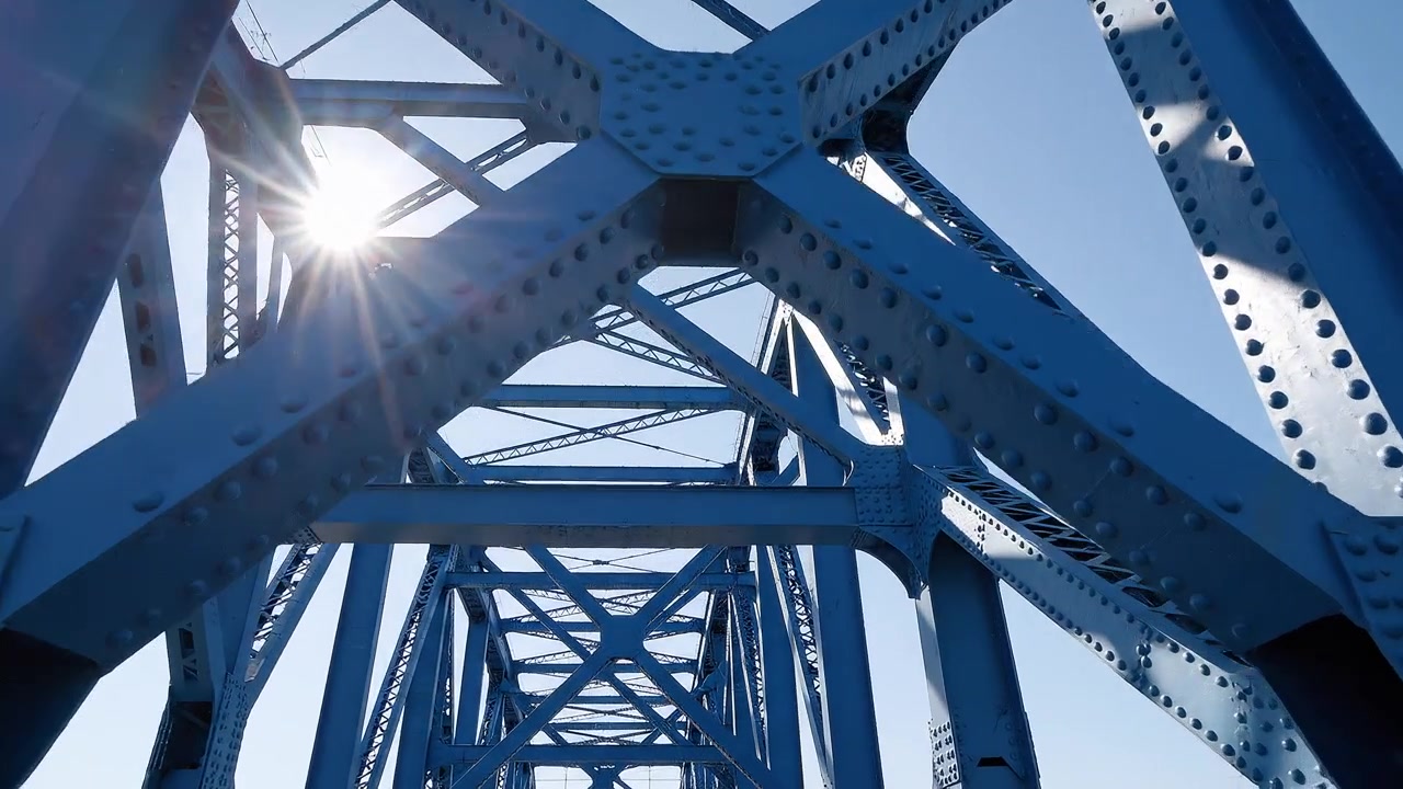 Close-up of Blue Metal Truss Bridge Structure and Engineering