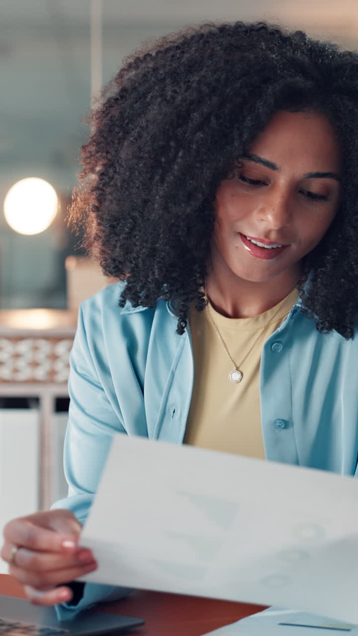 Professional Woman Smiling While Reading Document in Office