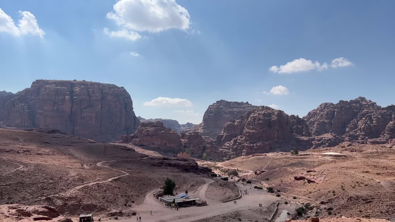 Petra valley in Wadi Musa, Jordan with The Treasury in the middle of a rocky and mountainous landscape, an UNESCO heritage site, ancient Nabatean Kingdom 4K Establish Shot