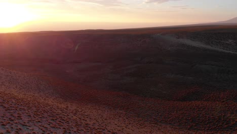 aerial cinematic shot going over a valley at sunset in the atacama desert, chile, south america
