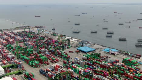 forward aerial of stacked containers at tanjung priok port, indonesia