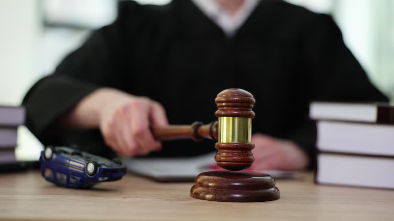 Judge with Gavel and Overturned Toy Car in Court