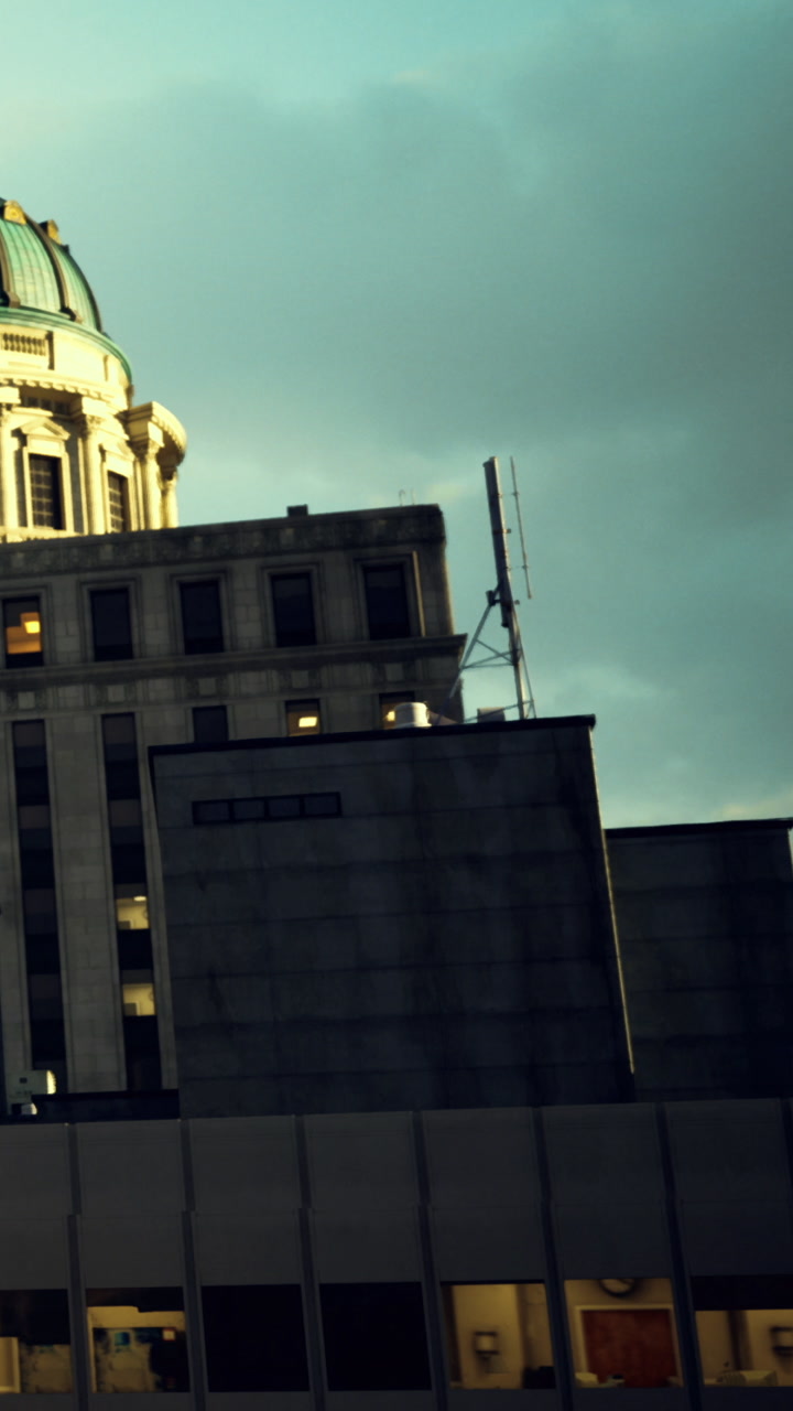 Cloudy skies embrace a historic building in a bustling city skyline