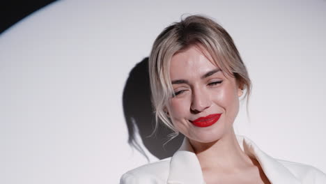 smiling woman in white blazer