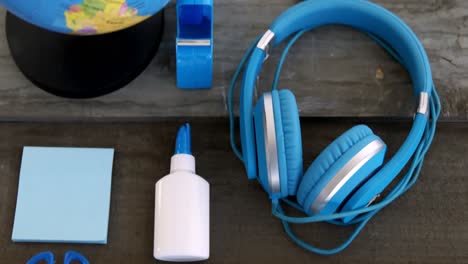 Headphone-with-other-stationery-on-wooden-table-4k