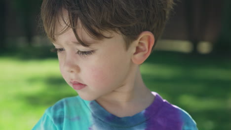 Close-up-portrait-shot-of-an-american-caucasian-child-boy-kid-in-the-yard