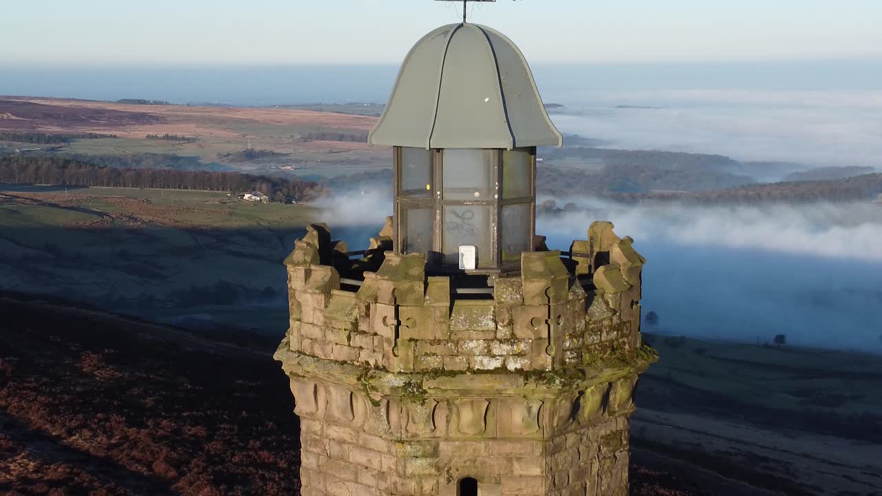 Darwen Jubilee tower top overlooking Lancashire hillside misty valley moorland countryside aerial descending