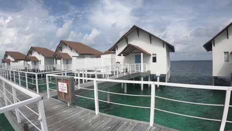 walking with bungalow in ocean sea at maldives