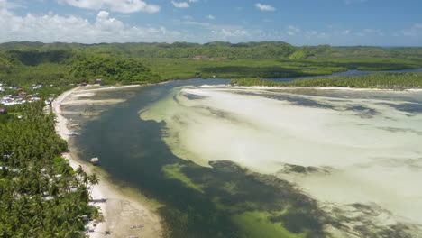 aerial showing bay between union beach and doot beach nearby general luna, siargao island, philippines