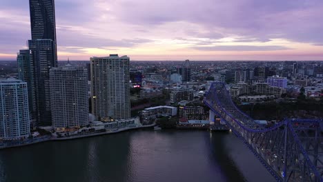 aerial shot of brisbane city and story bridge, push in shot flying towards howard smith wharves and fortitude valley, shot in evening light, flying over brisbane river