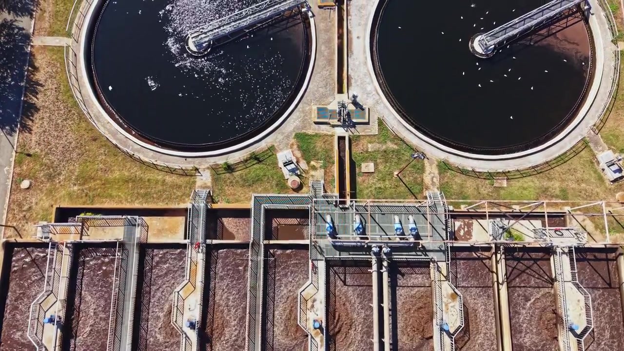 Water treatment facility overview with several treatment tanks and filtration systems in operation during daytime