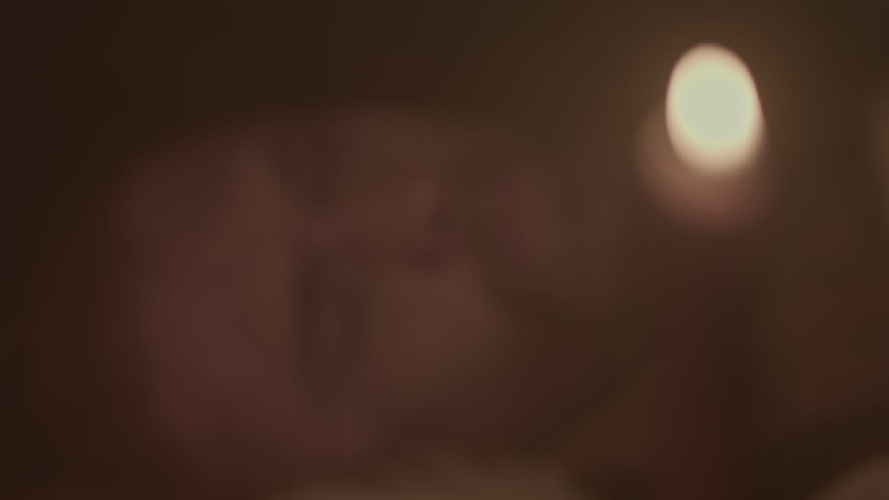 Close-up of a person at night with a candle