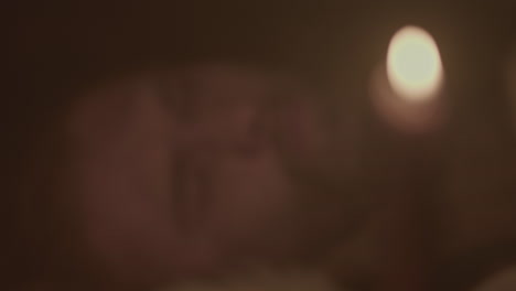 close-up of a person at night with a candle