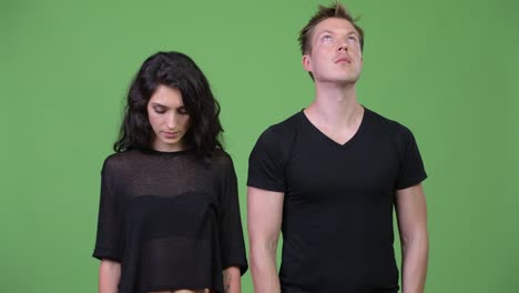 young couple looking in different directions together