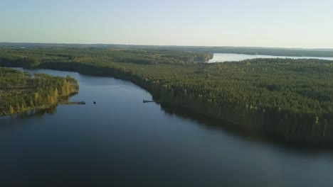 Wide-shot-of-a-lake-ferry-with-passengers,-clean-water,-deep-blue-sky,-autumn-trees