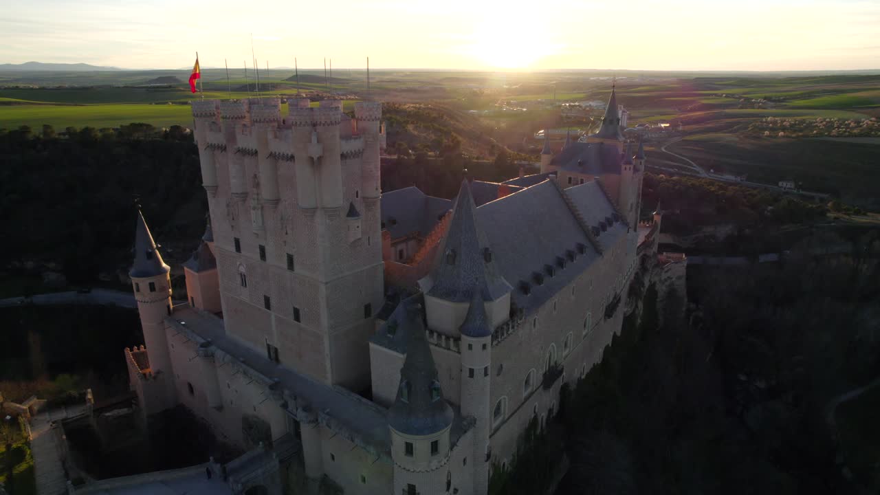 Cinematic aerial dolly in view of the Alcázar of Segovia medieval castle at sunset time