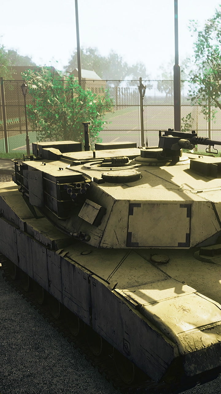 Military tank parked in a compound during daytime near trees and lamps
