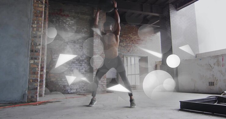 Fitness coach holding medicine ball overhead in loft as circles triangles swirling showing strength