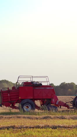 haymaking tractor on field. agriculture machine harvesting hay in fields