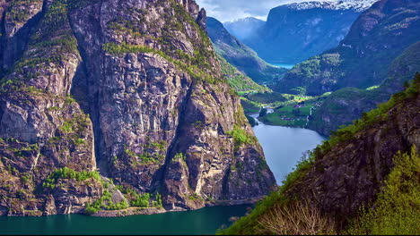 Clouds-casting-shadows-on-steep-rocky-mountain-valley,-fusion-time-lapse-view