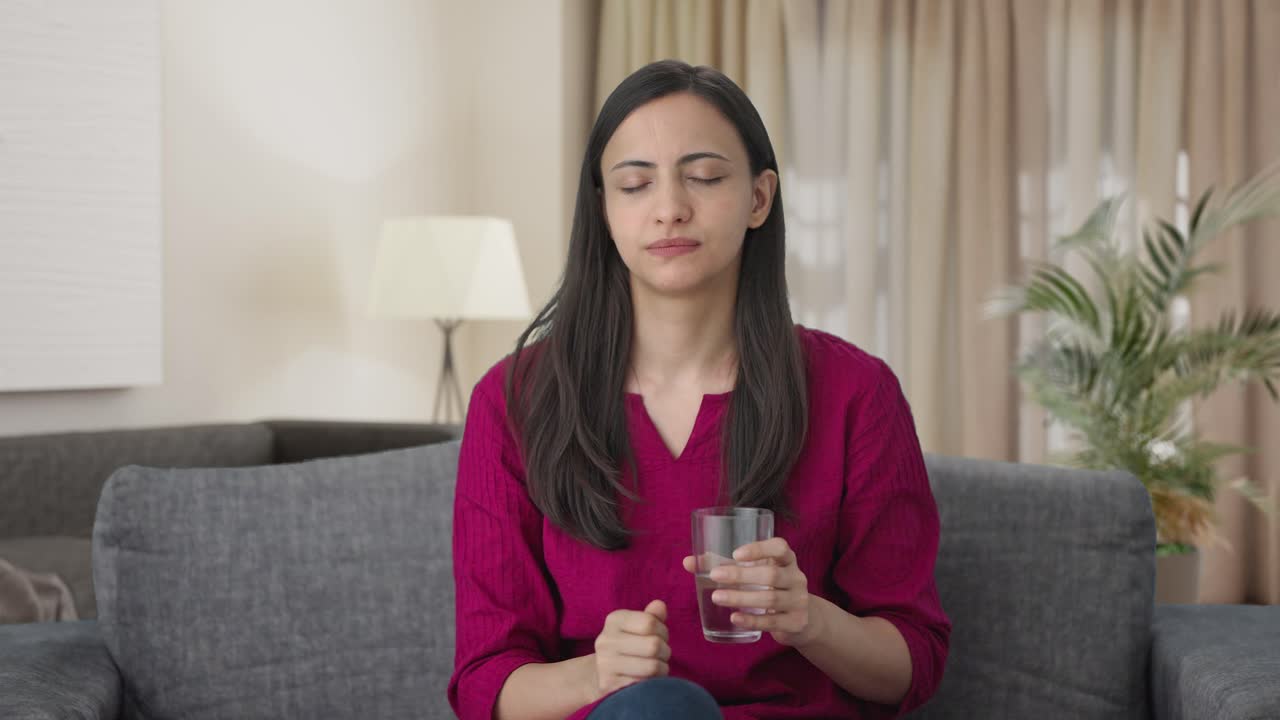 mujer india enferma tomando medicina