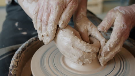 child and adult learning pottery together