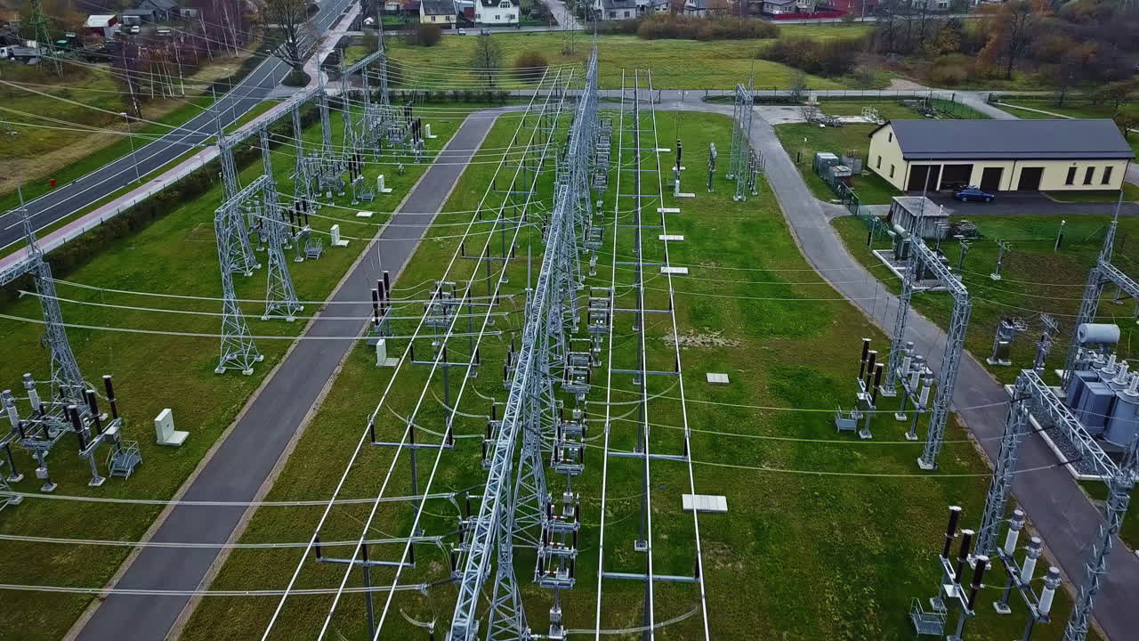 Aerial view over power lines, at a over electrical substation, on a gloomy day