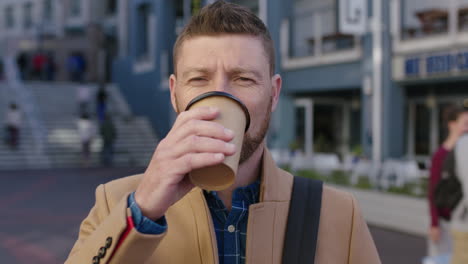 portrait-of-charming-caucasian-man-in-city-drinking-coffee-beverage-enjoying-urban-lifestyle