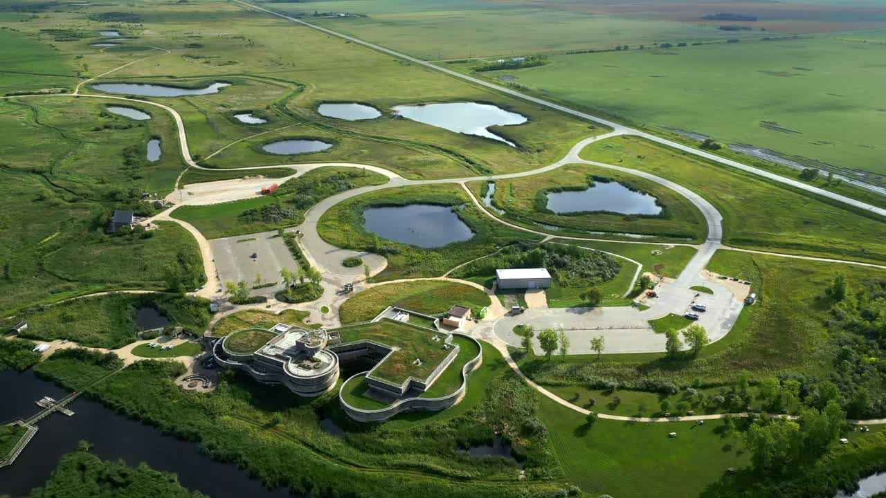 Futuristic green-roof centre mapped from above with roads, paths, wetlands