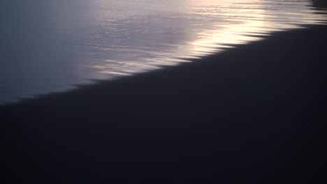 Relaxing-View-Of-The-Sea-Tide-Rolling-In-To-The-Shore-On-Sunset---Tilt-Down