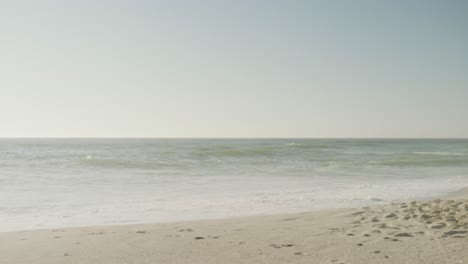 blue sky and sea with waves on empty and sunny beach