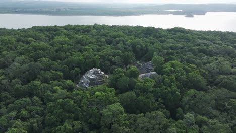 famous north acropolis maya ruins at yaxha in jungle, aerial