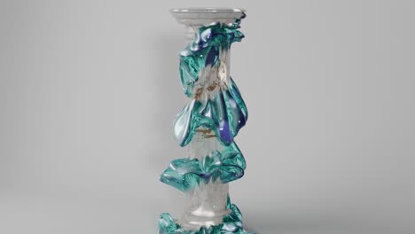 abstract marble column with teal glass design