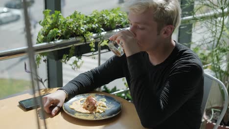 guy eating burger in restaurant