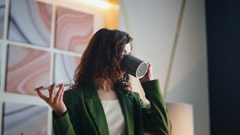 woman talking loudspeaker drinking coffee at workplace close up. ceo calling