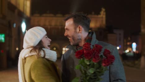 man with a bunch of roses waiting for his lady