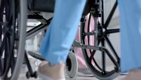 low section of diverse doctors walking in corridor at hospital, slow motion