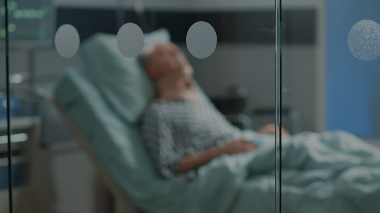 Sick old man laying in hospital ward bed with cervical neck collar