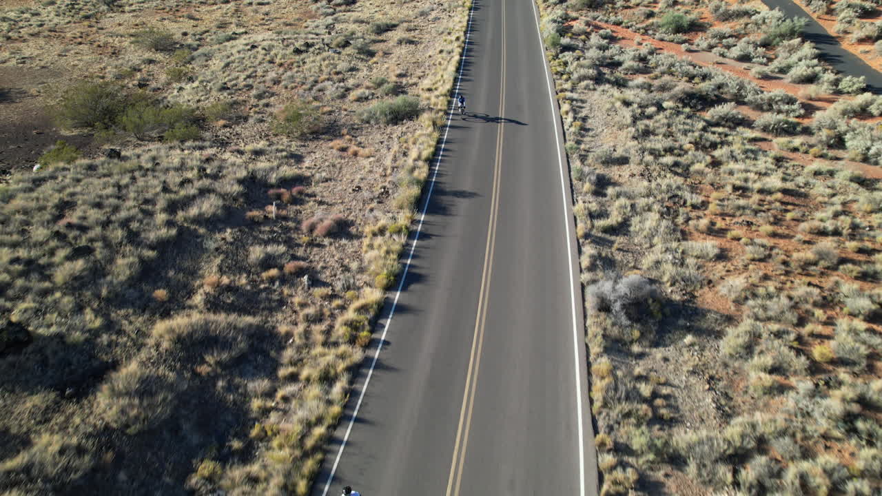 Aerial View of Cyclist on Desert Road