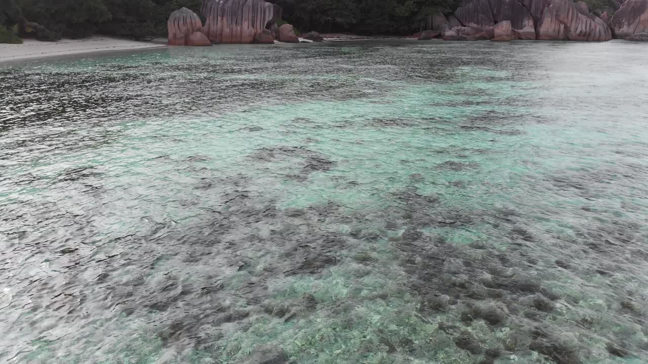 vista aérea de anse source d'argent, la digue, seychelles, filmada en las primeras horas de la mañana sin gente en la playa
