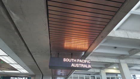 airport stop sign for new zealand and neighbor island at honolulu airport on oahu, hawaii. highlights the station's modern architectural details and illuminated signage