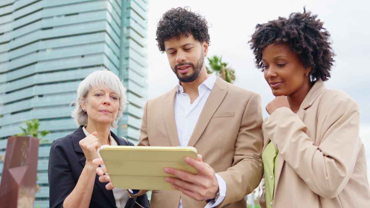 Diverse business team working together on a tablet