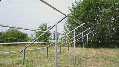 a view of ground-mounted photovoltaic system solar panel frames. low angle shot