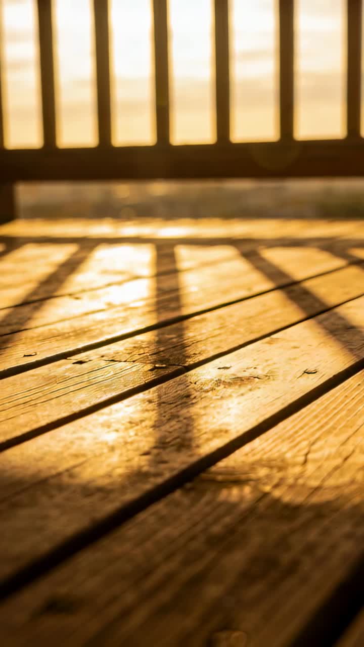 Sunlight shifting across wooden deck casting long railing shadows and revealing grain for design
